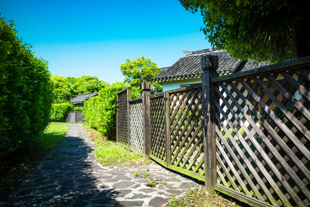 Wooden fence along stone path