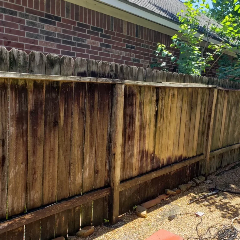 severely weathered wood fence with mold water damage dark stains before professional fence staining cleaning restoration service cypress houston texas