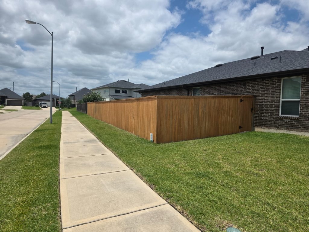 Tamarron HOA Fence Stained in Katy, Sherwin-Williams Color 2 Tamarron Katy fence before staining showing gray weathered pine boards